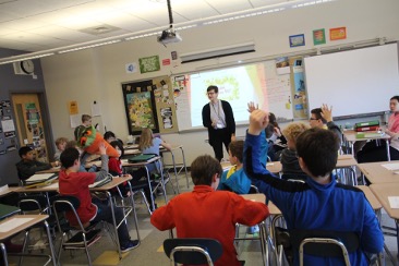 Samantha Shipeck teaching a class in a classroom filled with students sitting in desks.