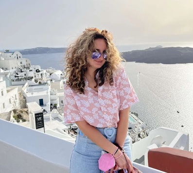 Jasmine al Rasheed poses from a rooftop in Greece.